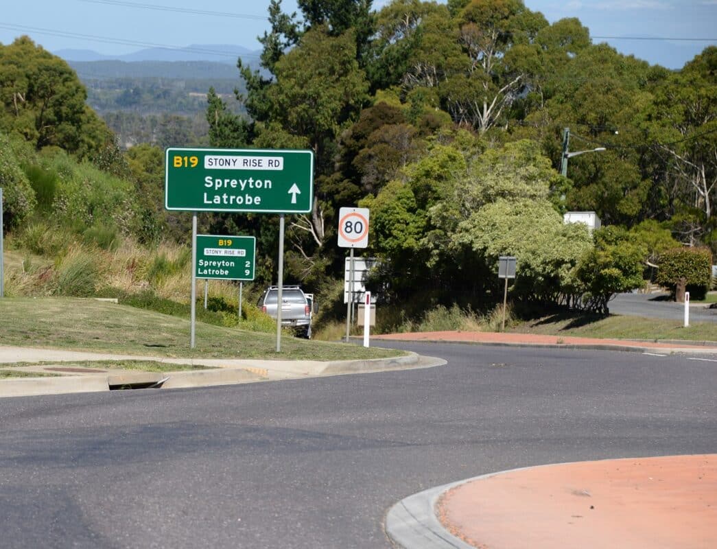 Large green and white street sign pointing to Stoney Rise Road, Spreyton and Latrobe.