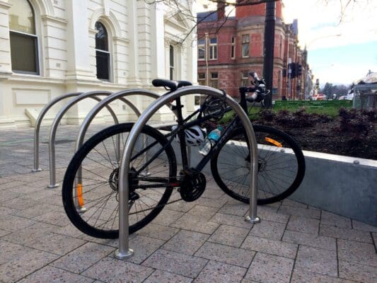 A bike locked onto a hoop outside the distinctive facade of the Launceston Town Hall from the Civic Square aspect.