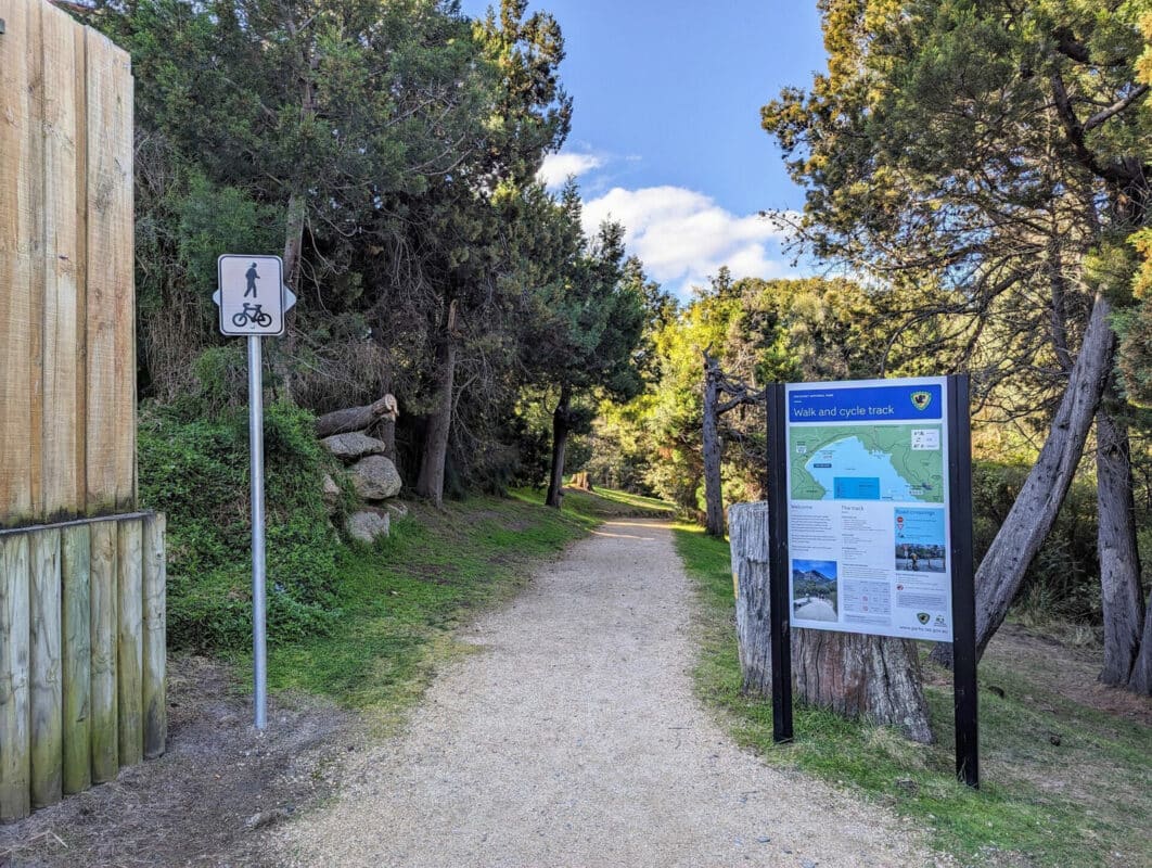 Freycinet graveltTrail with a shared path user sign to the left and a longer wayfinding sign for the park on the righ.t. 