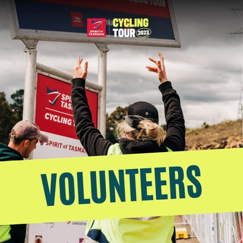 Graphic showing a rider throwing her hands in the air with a Spirit of Tasmania Cycling Tour sign in the background and over the top a yellow strip with VOLUNTEERS written in it.