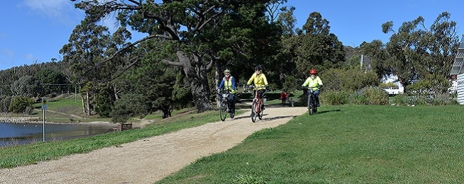 Three riders on a gravel path at Cornelian Bay in Hobart.