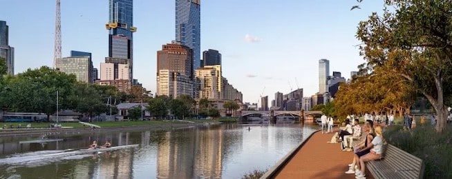 Artist illustration showing a completed Greenline path along the Yarra River, with city buildings in the background.